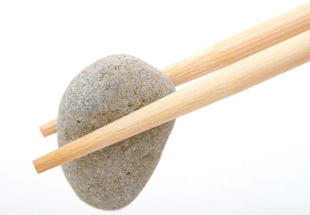 Chopsticks holding a stone