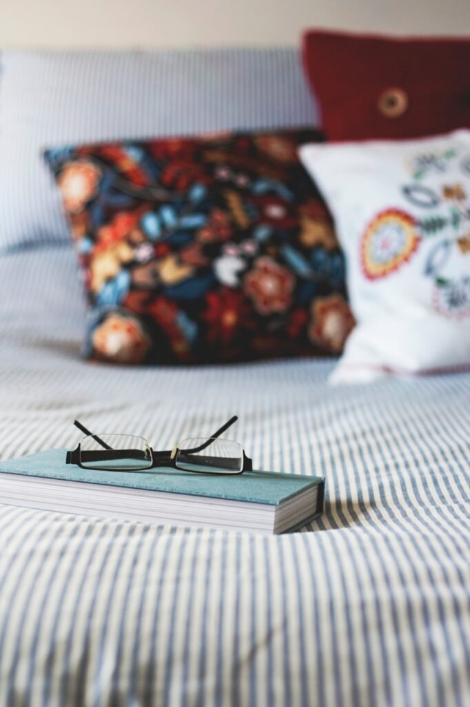 A bed with a book on the covers